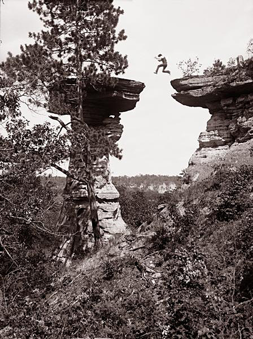 man jumpiing from cliff to cliff.